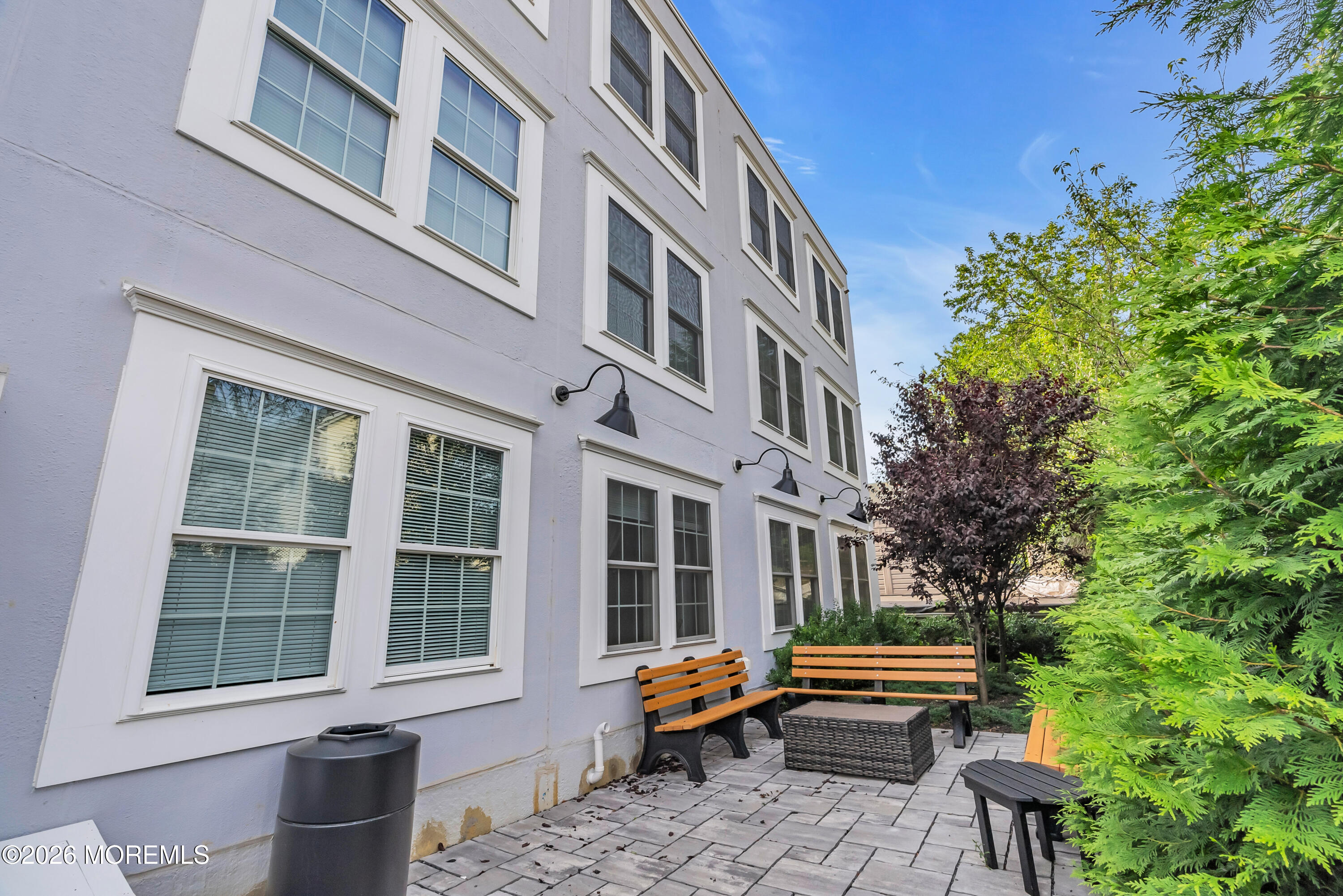 48 First Avenue, Unit 302 Atlantic Highlands, NJ 07716 - Photo 8 of 9 a bench is sitting in front of a building