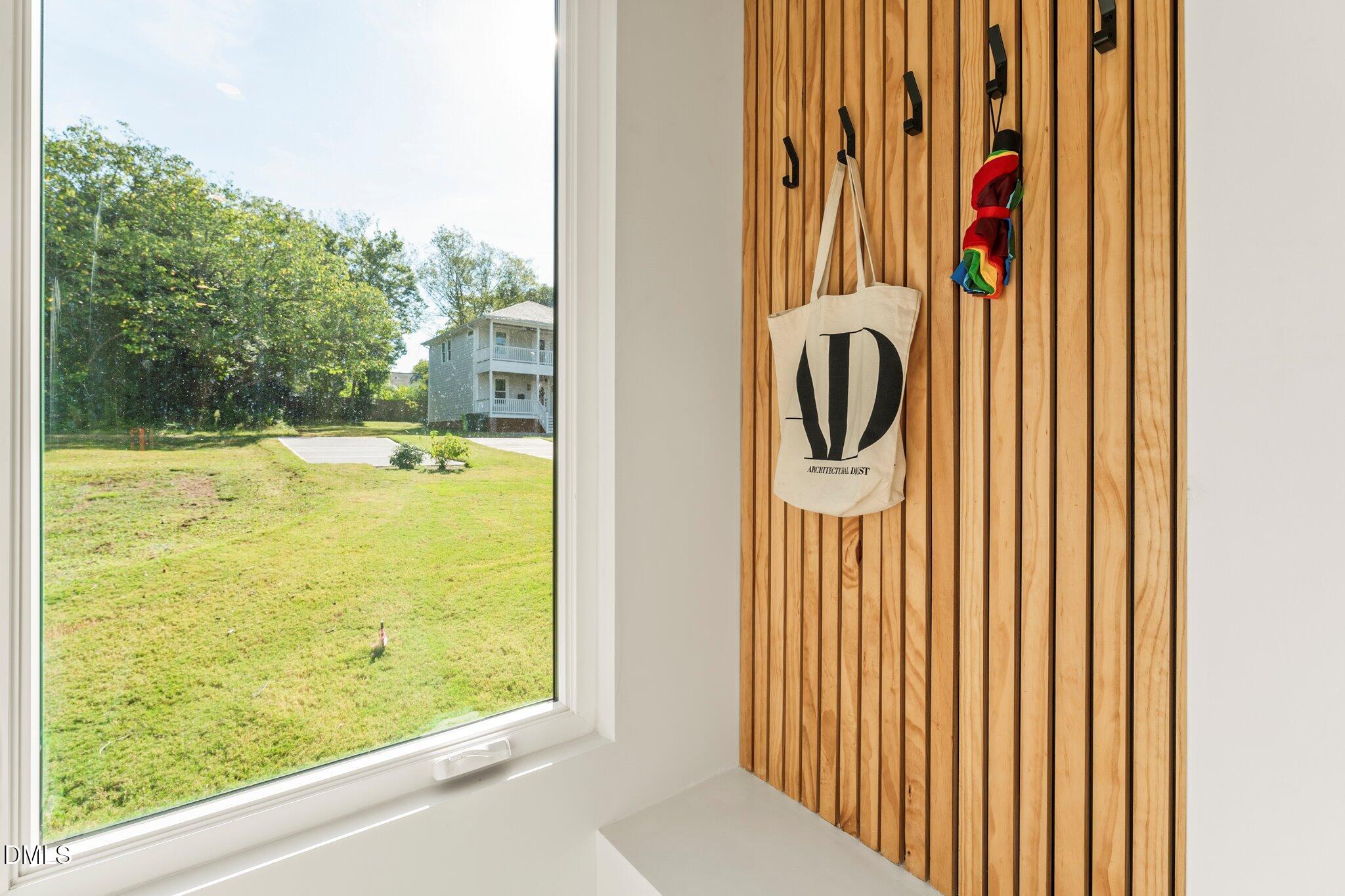409 Alston Street, Unit 101 Raleigh, NC 27601 - Photo 13 of 39 Every home needs a designated drop zone, but this is not your average drop zone. Thoughtfully designed as a feature wall with hooks. Outside you can see the private parking pads.