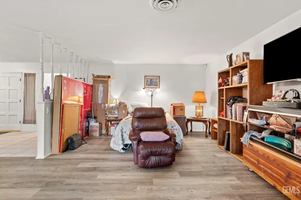 a dining room with furniture and wooden floor