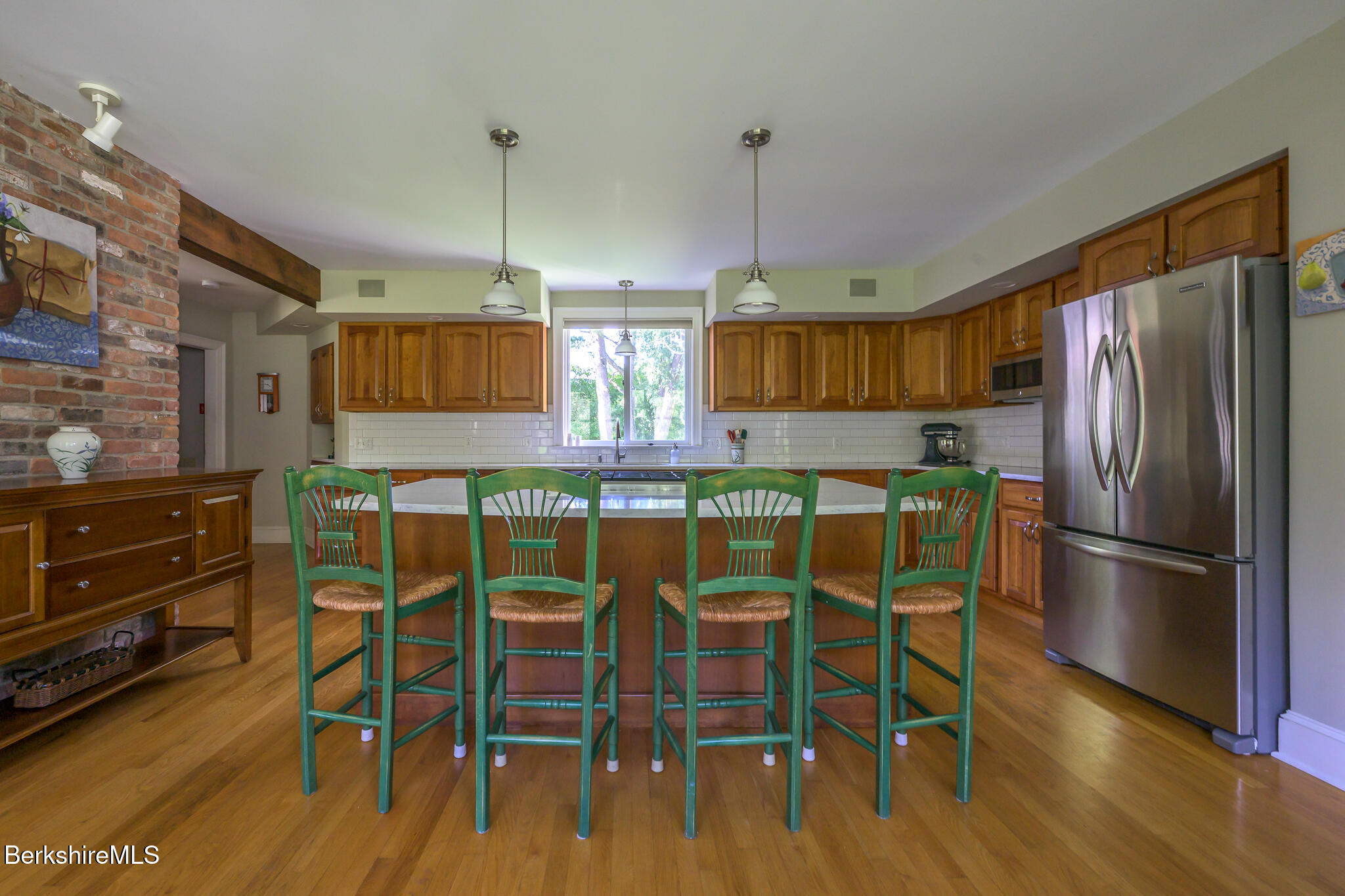 51 Albany Road West Stockbridge, MA 01266 - Photo 18 of 58 a kitchen with granite countertop a refrigerator cabinets wooden floor and stainless steel appliances