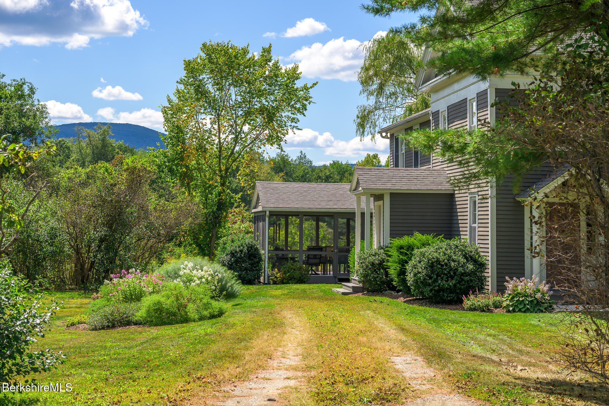 51 Albany Road West Stockbridge, MA 01266 - Photo 3 of 58 a view of a house with brick walls and a yard with plants