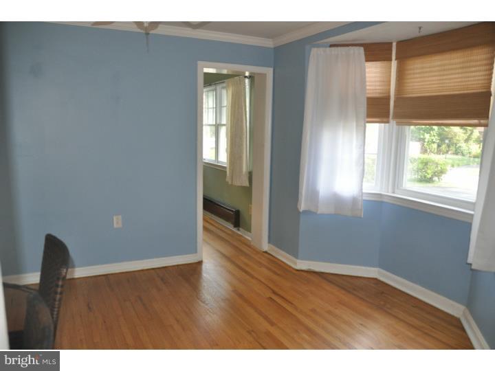 250 Fairview Road Springfield, PA 19064 - Photo 4 of 19 a view of an empty room with wooden floor and a window