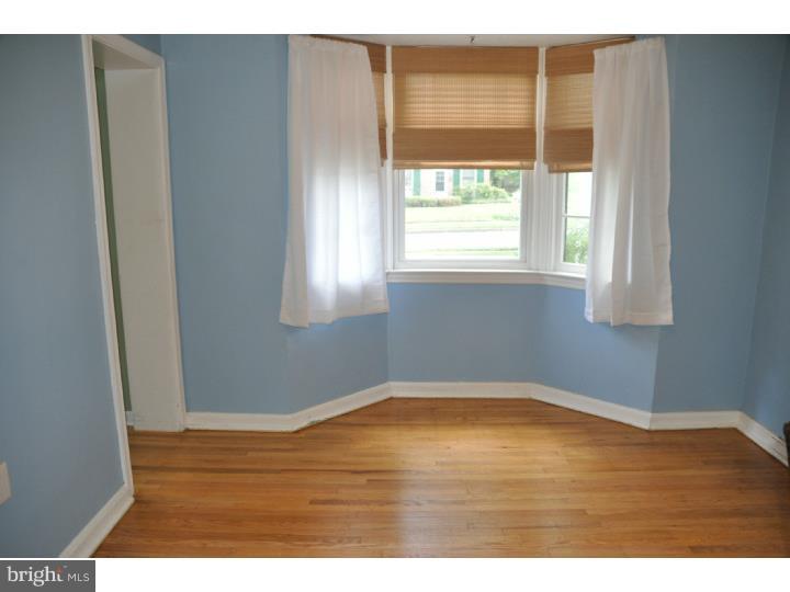 250 Fairview Road Springfield, PA 19064 - Photo 5 of 19 a view of an empty room with wooden floor and a window