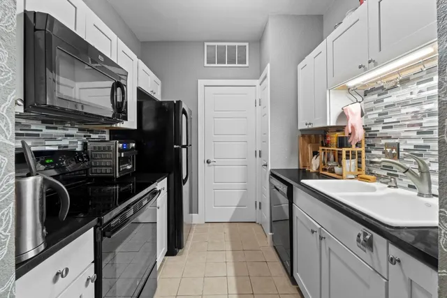 a kitchen with a sink stove and refrigerator