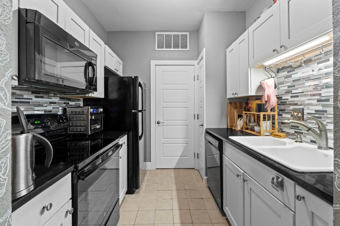 2804 Rio Grande Street, Unit 206 Austin, TX 78705 - Photo 5 of 21 a kitchen with a sink stove and refrigerator