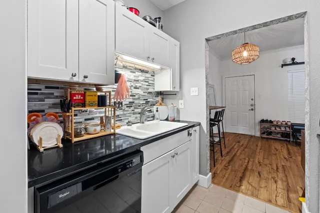 a kitchen that has a sink and cabinets