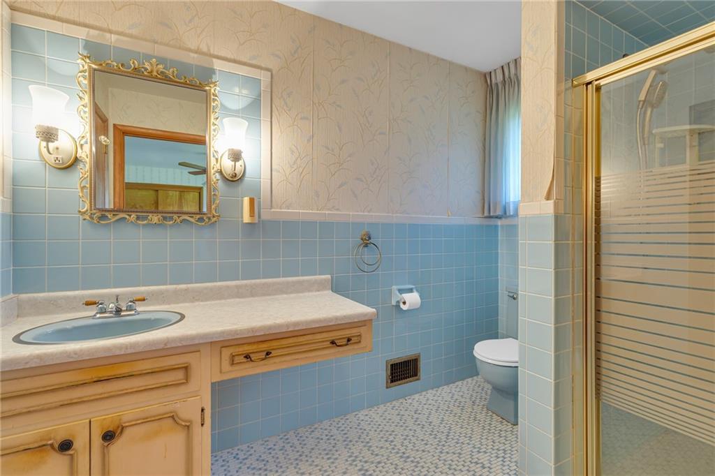 145 Oakhill Road Aliquippa, PA 15001 - Photo 19 of 23 a bathroom with a sink a toilet a mirror and shower