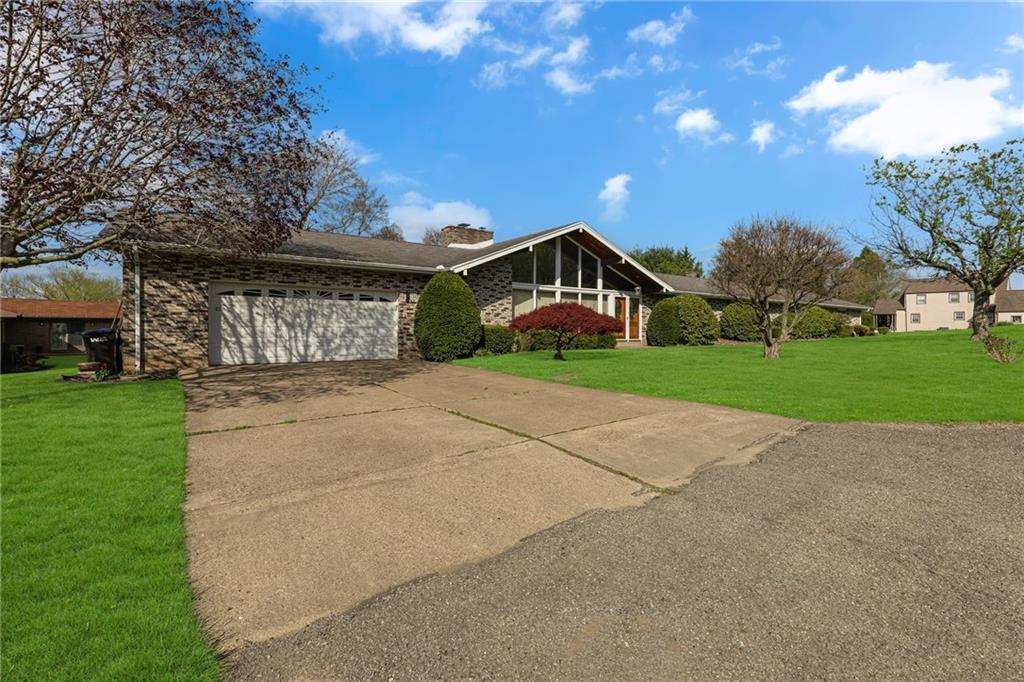 145 Oakhill Road Aliquippa, PA 15001 - Photo 2 of 23 a front view of a house with a yard and garage