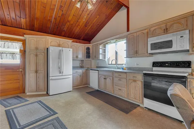 a kitchen with white cabinets and white appliances