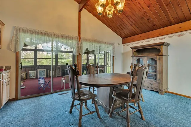 a view of a dining room with furniture and window