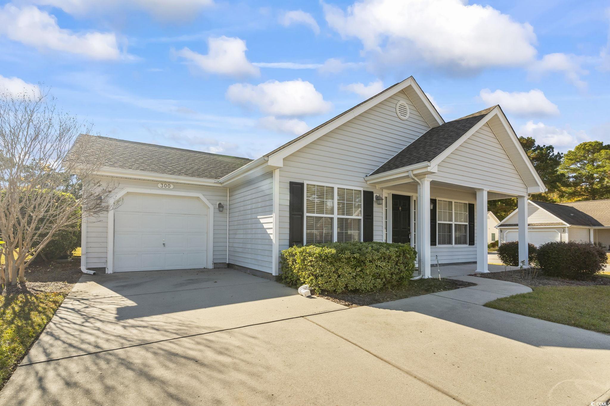 Beautiful front view of this fully furnished single-level home with attached 1-car garage.