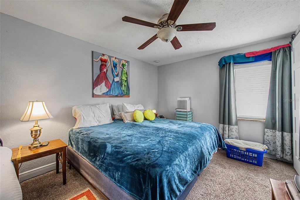 1632 Pintail Court Lutz, FL 33549 - Photo 17 of 34 a bedroom with a bed and a chandelier
