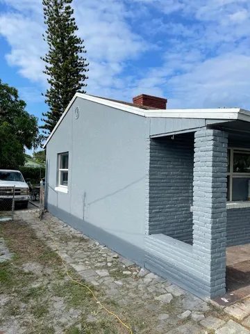 a view of backyard with barbeque grill and plants