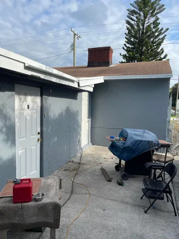 a backyard of a house with seating space and furniture