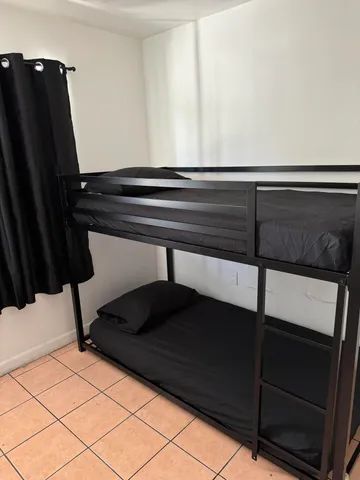 a bed sitting in a bedroom next to a window