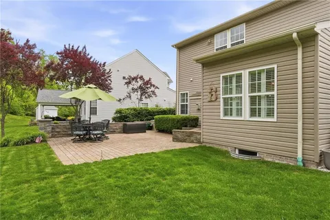 a view of a house with a backyard and sitting area