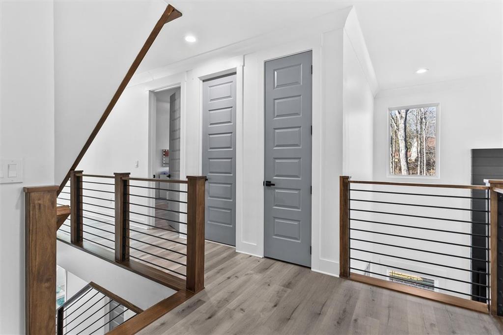 658 Rockbridge Road Northwest Lilburn, GA 30047 - Photo 21 of 61 a view of a hallway with stairs and wooden floor