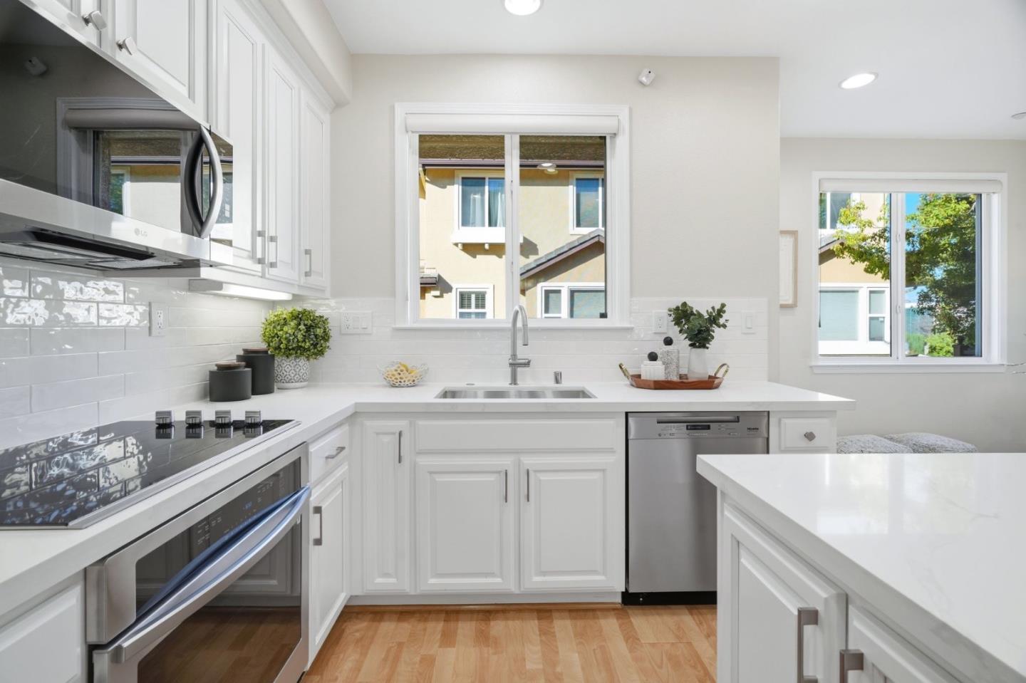 5050 Ruffino Terrace San Jose, CA 95129 - Photo 11 of 26 a kitchen with a sink stove and cabinets