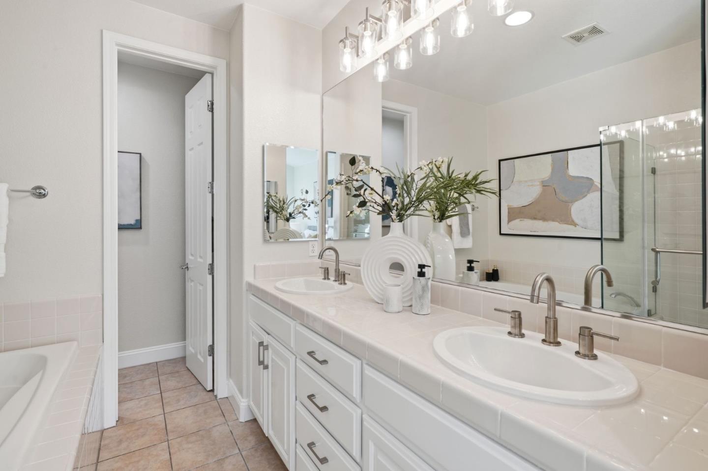 5050 Ruffino Terrace San Jose, CA 95129 - Photo 16 of 26 a bathroom with double sink and a mirror