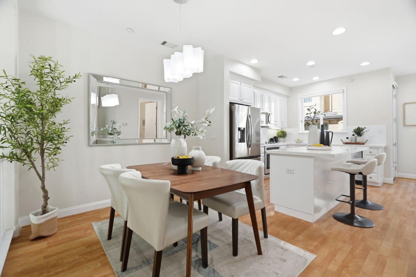 5050 Ruffino Terrace San Jose, CA 95129 - Photo 3 of 26 a view of a dining room with furniture and wooden floor