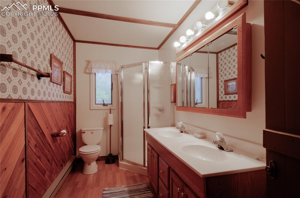 9455 Mohawk Trail Cascade, CO 80809 - Photo 12 of 33 Primary bath with double sinks and walk in shower Base board heat in Primary Bedroom and Bath