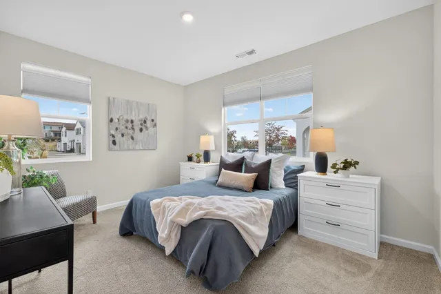 a bedroom with a bed and a couch