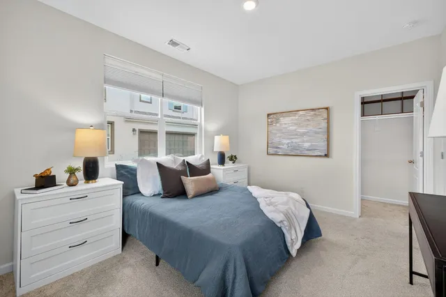 a bedroom with a bed and lamp