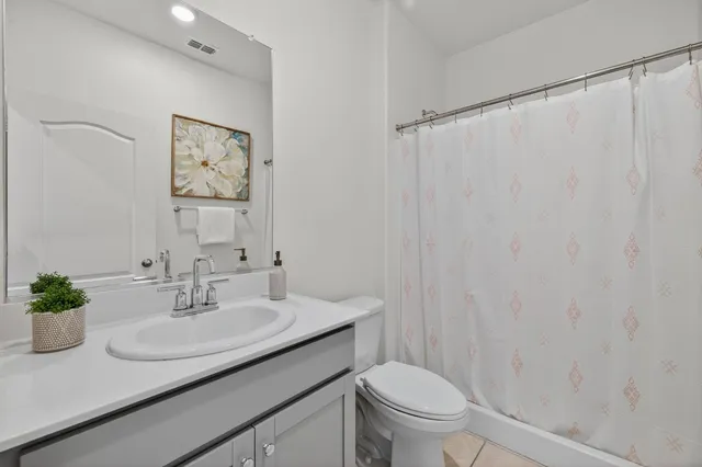 a bathroom with a sink toilet and a mirror