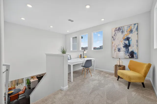 a living room with furniture and a chair