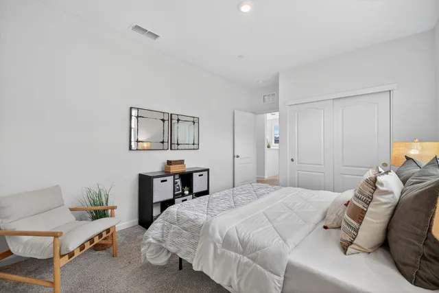 a bedroom with a bed and a desk