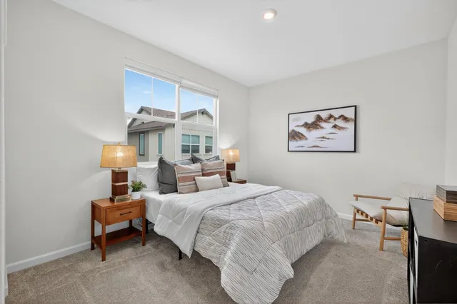 a bedroom with a bed and a lamp