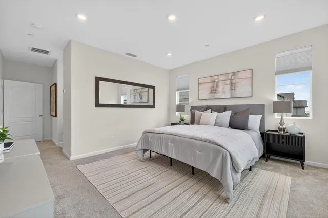 a spacious bedroom with a large bed and a couch