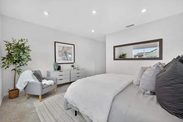 a bedroom with a bed and a couch