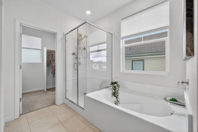 a spacious bathroom with a bathtub shower and a sink