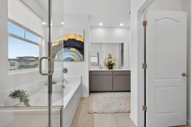 a bathroom with a bathtub a sink and a mirror