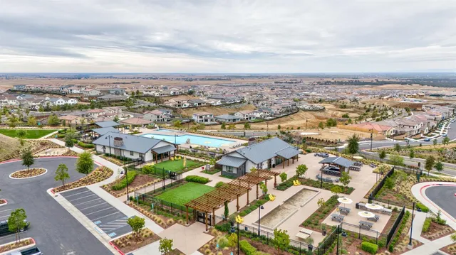 an aerial view of residential building with green space