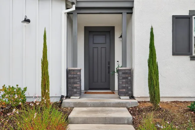a front view of a house with a garden