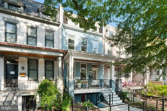 front view of a brick house with a large windows