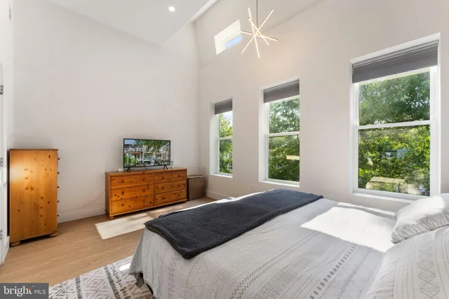 a bedroom with a bed and a dresser in it