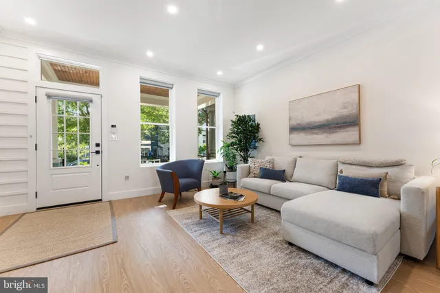 a living room with furniture and large windows