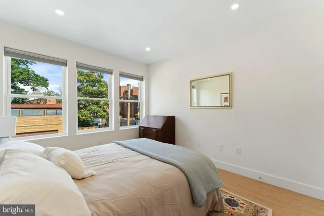 a bedroom with a large bed and a window