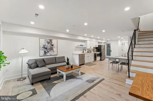 a living room with furniture and wooden floor