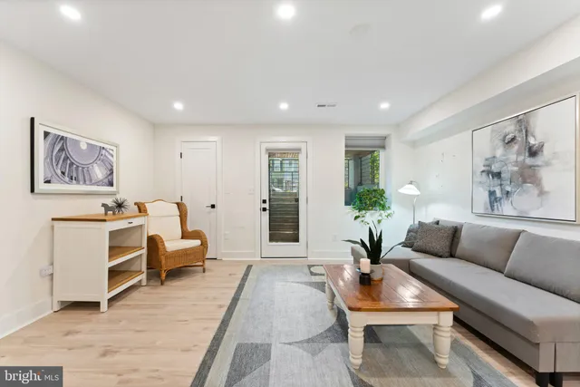 a living room with furniture potted plant and windows