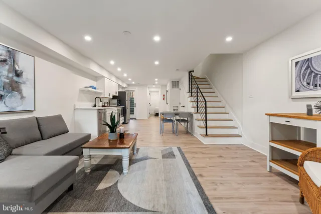 a living room with furniture and wooden floor