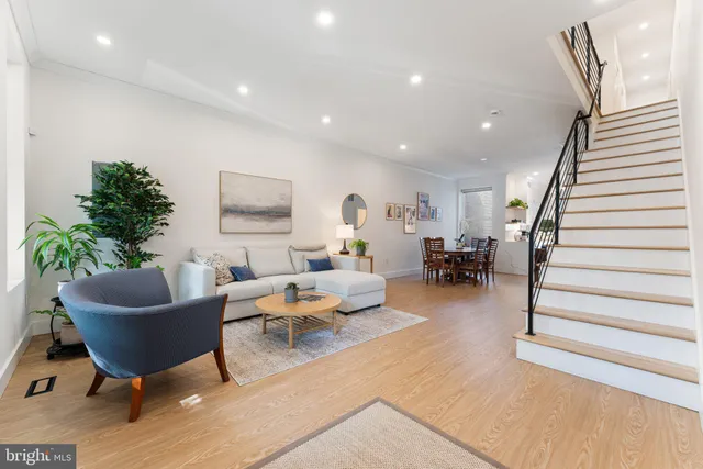a living room with furniture and a potted plant