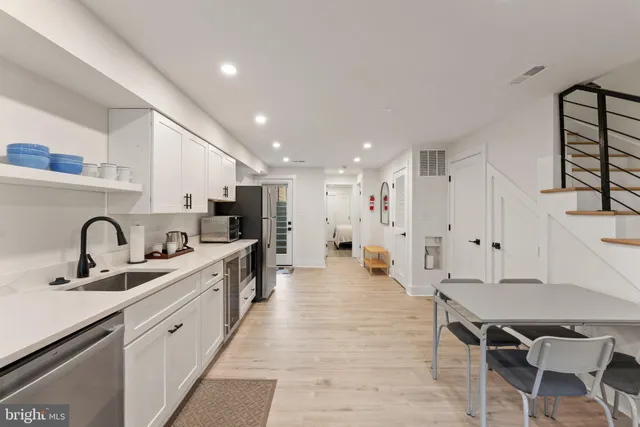 a large kitchen with stainless steel appliances lots of counter space and a sink