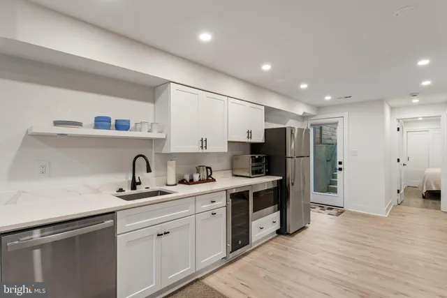 a kitchen with a sink stainless steel appliances and cabinets