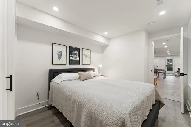 a bedroom with a bed and a large mirror