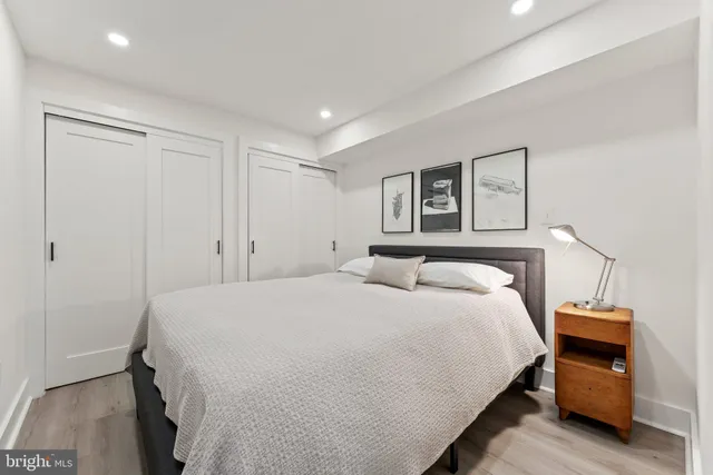 a bedroom with a bed and a night stand