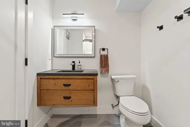 a bathroom with a toilet sink and mirror